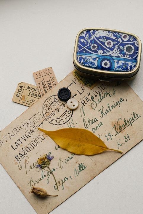 A postcard, two buttons, one leaf