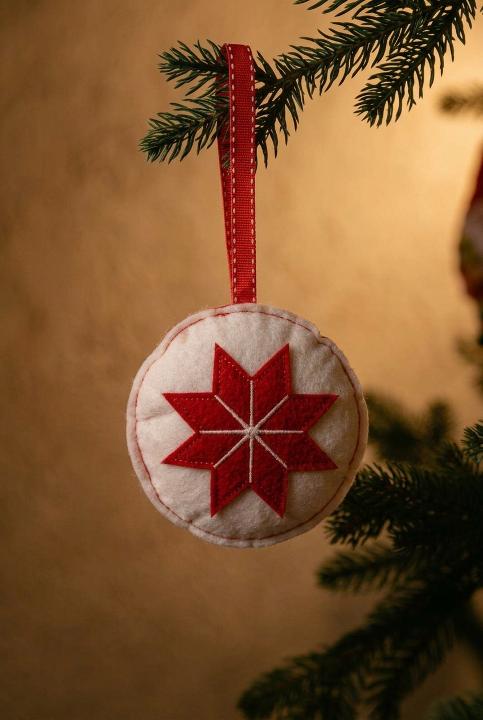Embroidered round ornament on a branch