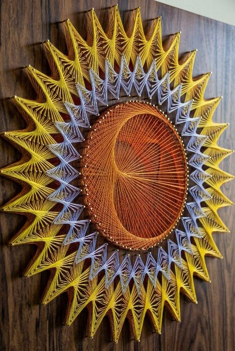 Thread sunburst on dark wood