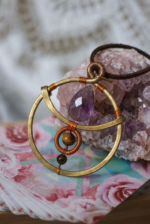 Amethyst caught in brass circles
