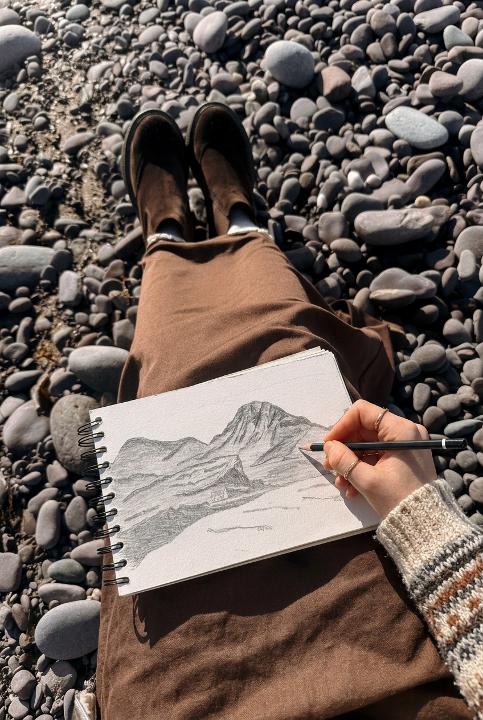 Sketching from a pebble beach